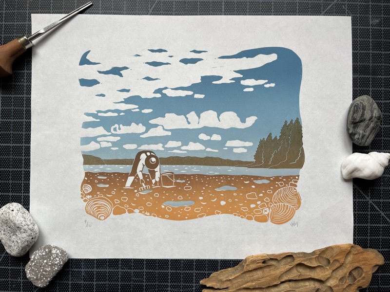 Linocut print of a person digging clams on a beach under a blue sky