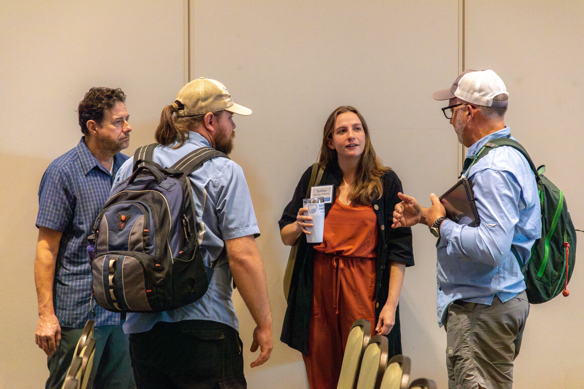 Delegates gathered in conversation during a break