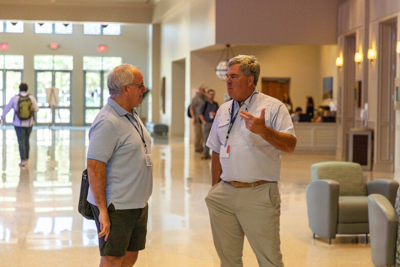 Two delegates talking in the conference concourse